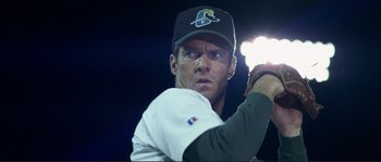 Movie still from “The Rookie” (2002), directed by John Lee Hancock – A man in a baseball uniform holding a baseball bat; Close Up shot, Low angle