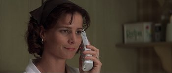 Movie still from “The Rookie” (2002), directed by John Lee Hancock – A woman holding a phone up to her ear; Close Up shot, Low angle