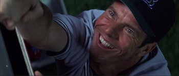 Movie still from “The Rookie” (2002), directed by John Lee Hancock – A man smiling for the camera; Close Up shot, Low angle