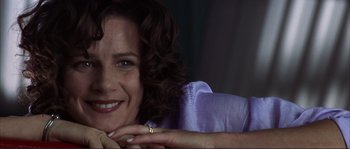 Movie still from “The Rookie” (2002), directed by John Lee Hancock – A person smiling with her hand on her chin; Close Up shot, Low angle