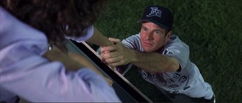 Movie still from “The Rookie” (2002), directed by John Lee Hancock – A baseball player shaking hands with another player; Medium shot, Over the shoulder angle