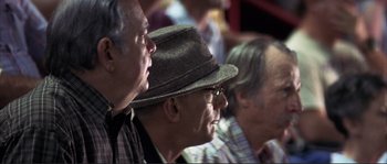 Movie still from “The Rookie” (2002), directed by John Lee Hancock – A group of men sitting next to each other in a room; Close Up shot, Low angle