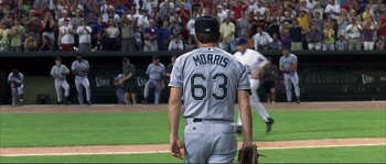 Movie still from “The Rookie” (2002), directed by John Lee Hancock – A baseball player is walking on a field; Medium shot, Low angle