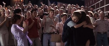 Movie still from “The Rookie” (2002), directed by John Lee Hancock – A group of people standing in front of a crowd; Medium shot, Over the shoulder angle