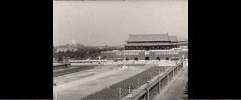Movie still from “The Sacrifice” (2020), directed by Yang Lu – An old photo of a stadium in a city; Extreme Wide shot, High angle