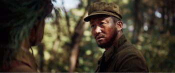 Movie still from “The Sacrifice” (2020), directed by Yang Lu – A person wearing a hat; Close Up shot, Low angle
