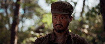 Movie still from “The Sacrifice” (2020), directed by Yang Lu – A person wearing a hat; Close Up shot, Low angle