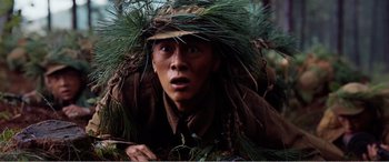 Movie still from “The Sacrifice” (2020), directed by Yang Lu – A man with a hat and a beard in the woods; Close Up shot, High angle