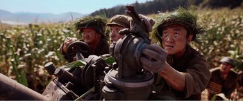 Movie still from “The Sacrifice” (2020), directed by Yang Lu – A group of men in military uniforms are looking at the camera; Close Up shot, Low angle