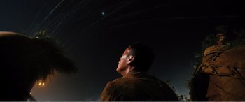 Movie still from “The Sacrifice” (2020), directed by Yang Lu – A man looking up into the sky at night; Medium shot, Low angle