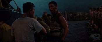 Movie still from “The Sacrifice” (2020), directed by Yang Lu – A man is yelling at another man in the background; Medium shot, Over the shoulder angle