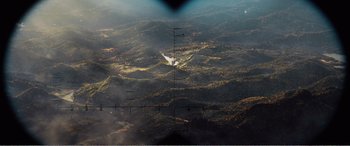 Movie still from “The Sacrifice” (2020), directed by Yang Lu – An aerial view of a mountain range with a plane flying overhead; Extreme Wide shot, Overhead angle