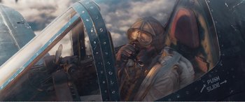 Movie still from “The Sacrifice” (2020), directed by Yang Lu – A painting of a man wearing a gas mask; Medium shot, Low angle