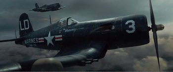 Movie still from “The Sacrifice” (2020), directed by Yang Lu – An old fighter plane flying through the sky; Wide shot, Overhead angle