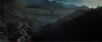 Movie still from “The Sacrifice” (2020), directed by Yang Lu – A view of a valley with a train on the tracks; Extreme Wide shot, High angle