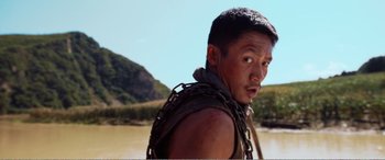 Movie still from “The Sacrifice” (2020), directed by Yang Lu – A person wearing chains on their shoulders; Close Up shot, Over the shoulder angle