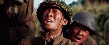 Movie still from “The Sacrifice” (2020), directed by Yang Lu – A man in a military uniform with a hat on his head; Close Up shot, Low angle