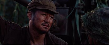 Movie still from “The Sacrifice” (2020), directed by Yang Lu – A person wearing a hat; Close Up shot, Low angle
