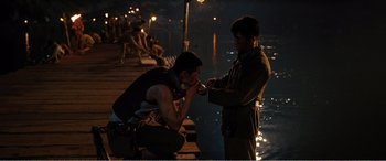 Movie still from “The Sacrifice” (2020), directed by Yang Lu – Two men on a pier at night with lights on; Medium shot, Over the shoulder angle