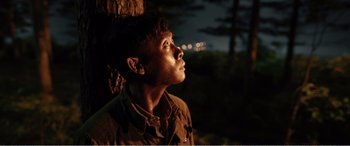 Movie still from “The Sacrifice” (2020), directed by Yang Lu – A man looking up at the sky at night; Close Up shot, High angle