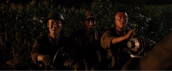 Movie still from “The Sacrifice” (2020), directed by Yang Lu – A group of men standing next to each other in the dark; Medium shot, High angle