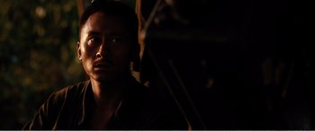 Movie still from “The Sacrifice” (2020), directed by Yang Lu – A person in a dark room; Close Up shot, High angle