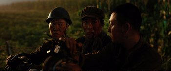 Movie still from “The Sacrifice” (2020), directed by Yang Lu – A group of men standing next to each other; Close Up shot, Over the shoulder angle