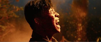 Movie still from “The Sacrifice” (2020), directed by Yang Lu – A young man with blood all over his face; Close Up shot, Low angle
