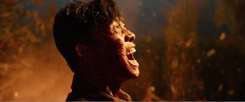 Movie still from “The Sacrifice” (2020), directed by Yang Lu – A man's face with a fake mouth; Close Up shot, Low angle