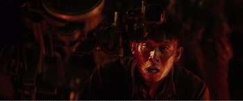 Movie still from “The Sacrifice” (2020), directed by Yang Lu – A man with red eyes and a red face; Close Up shot, Overhead angle
