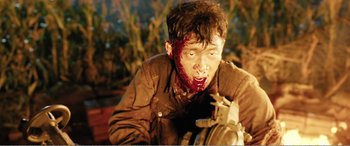 Movie still from “The Sacrifice” (2020), directed by Yang Lu – A man with blood all over his face; Medium shot, Low angle