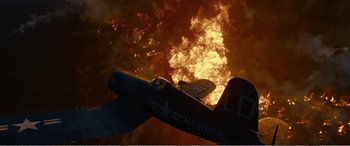 Movie still from “The Sacrifice” (2020), directed by Yang Lu – An airplane is flying through the sky with a lot of smoke; Extreme Wide shot, Low angle