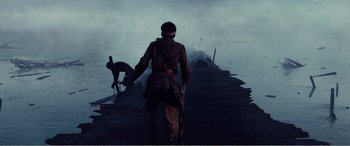 Movie still from “The Sacrifice” (2020), directed by Yang Lu – A man standing on top of a boat in the water; Wide shot, Over the shoulder angle