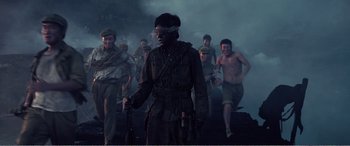 Movie still from “The Sacrifice” (2020), directed by Yang Lu – A group of men walking through a dark area; Wide shot, Over the shoulder angle