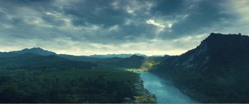 Movie still from “The Sacrifice” (2020), directed by Yang Lu – A view of a body of water with a mountain range in the background; Extreme Wide shot, High angle