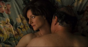 Movie still from “The Savages” (2007), directed by Tamara Jenkins – A man and a woman in a bed with flowers; Close Up shot, Overhead angle