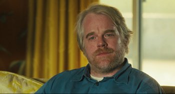 Movie still from “The Savages” (2007), directed by Tamara Jenkins – A person sitting in a room; Close Up shot, Over the shoulder angle