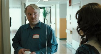 Movie still from “The Savages” (2007), directed by Tamara Jenkins – A man standing in front of a woman holding a coffee cup; Medium shot, Over the shoulder angle