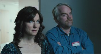 Movie still from “The Savages” (2007), directed by Tamara Jenkins – A woman and a man sitting next to each other in a room; Close Up shot, Over the shoulder angle