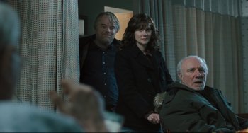 Movie still from “The Savages” (2007), directed by Tamara Jenkins – A man and a woman standing next to each other; Medium shot, Over the shoulder angle