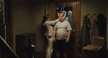 Movie still from “The Savages” (2007), directed by Tamara Jenkins – A woman and a man standing next to each other in front of a door; Medium shot, Over the shoulder angle