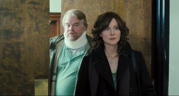 Movie still from “The Savages” (2007), directed by Tamara Jenkins – A man and a woman standing next to each other; Medium shot, Over the shoulder angle