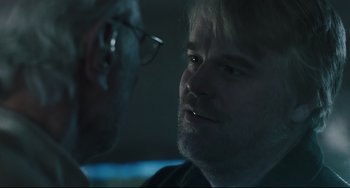 Movie still from “The Savages” (2007), directed by Tamara Jenkins – A man with glasses is looking at another man with glasses; Close Up shot, Over the shoulder angle