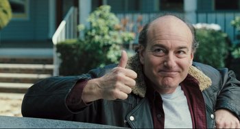 Movie still from “The Savages” (2007), directed by Tamara Jenkins – A man giving a thumbs up while wearing a leather jacket; Close Up shot, Low angle