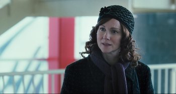 Movie still from “The Savages” (2007), directed by Tamara Jenkins – A person wearing a hat and a scarf; Close Up shot, Over the shoulder angle