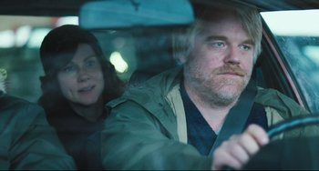 Movie still from “The Savages” (2007), directed by Tamara Jenkins – A man and a woman in the back seat of a car; Close Up shot, Over the shoulder angle