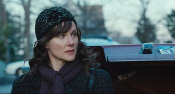 Movie still from “The Savages” (2007), directed by Tamara Jenkins – A person wearing a hat and a scarf; Close Up shot, Over the shoulder angle
