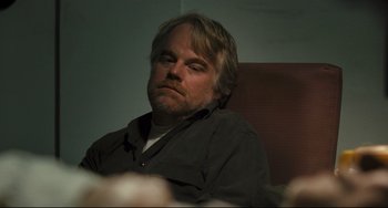 Movie still from “The Savages” (2007), directed by Tamara Jenkins – A person sitting in a chair; Close Up shot, Over the shoulder angle