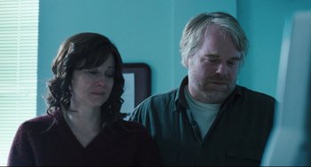 Movie still from “The Savages” (2007), directed by Tamara Jenkins – A man and a woman standing next to each other in a room; Medium shot, Over the shoulder angle