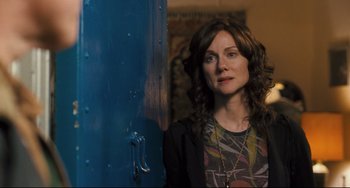 Movie still from “The Savages” (2007), directed by Tamara Jenkins – A woman standing in front of a blue door; Medium shot, Over the shoulder angle